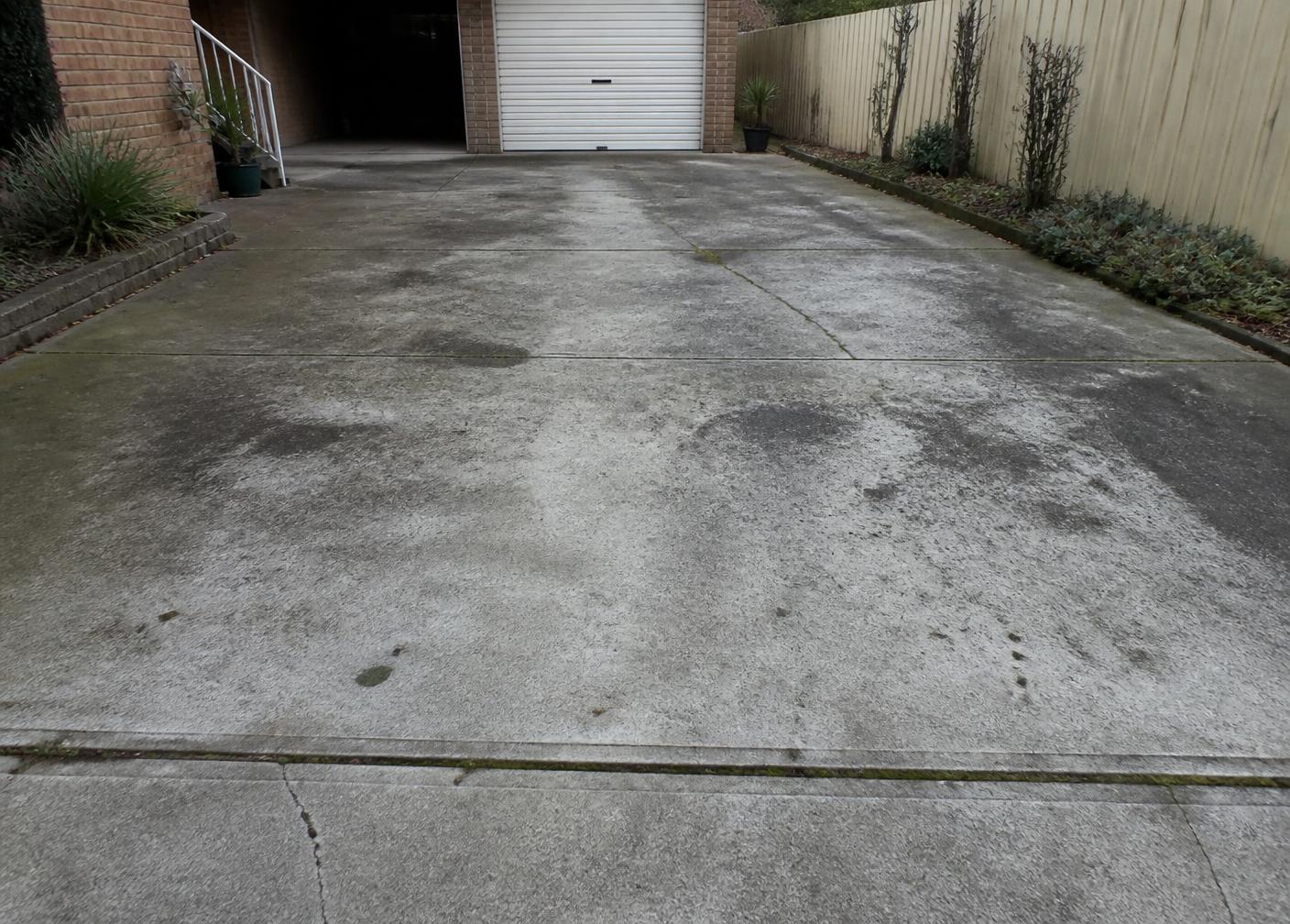 Weathered concrete driveway before cleaning and sealing